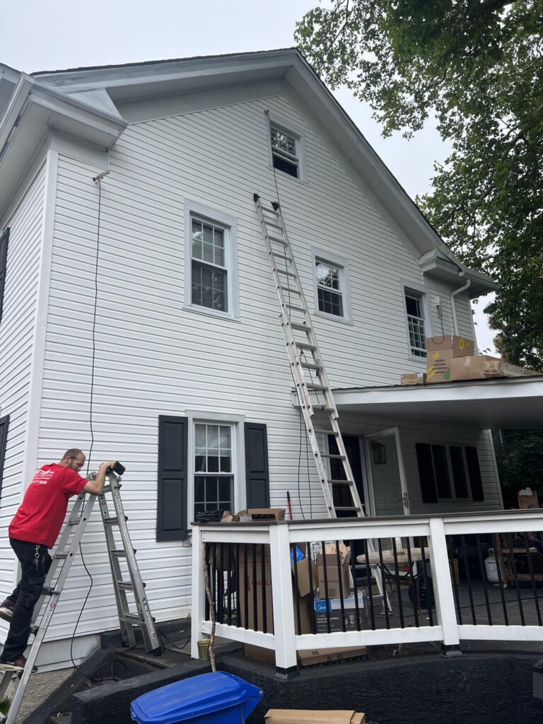 Workers working on 2 story white house