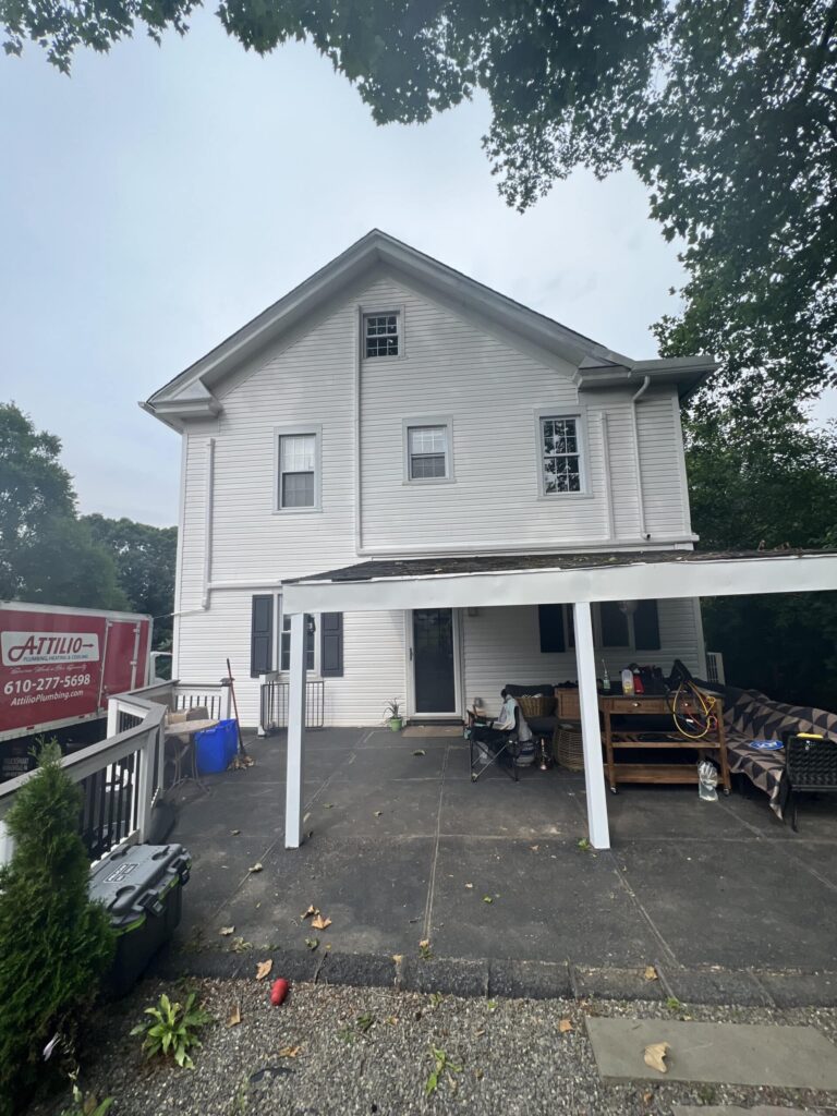 Attilio truck parked outside of white two story house