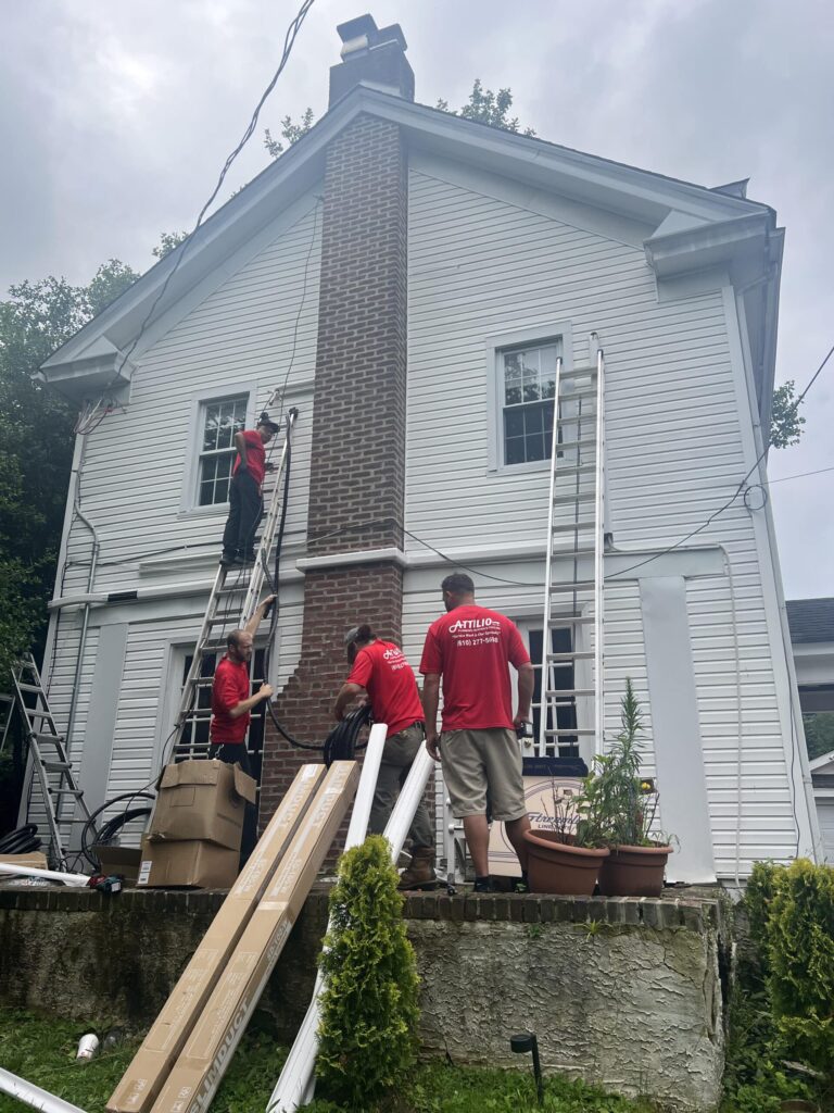 Workers working on 2 story white house