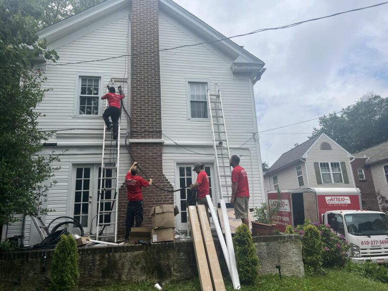 Workers working on 2 story white house